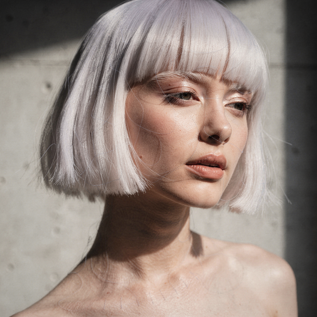 White platinum razor bob haircut with bangs.