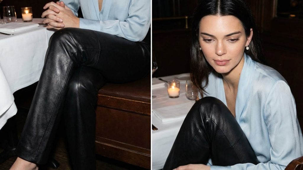 Kendall Jenner in black leather pants and a light blue silk blouse at dinner.