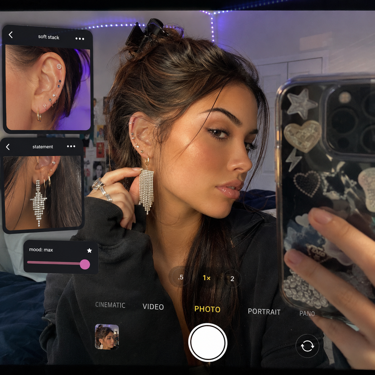 Woman taking mirror selfie showing multiple ear piercings and dangling earrings, with phone camera interface overlays.