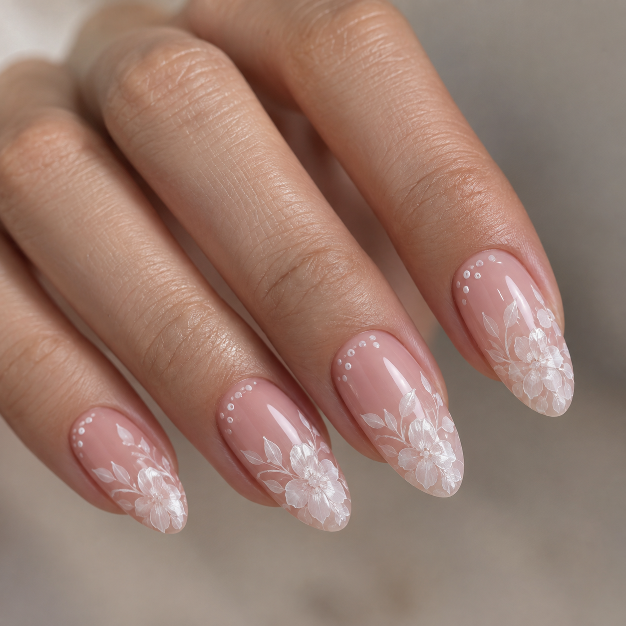 Sheer pink nails with white floral lace and tiny dots near the cuticles.