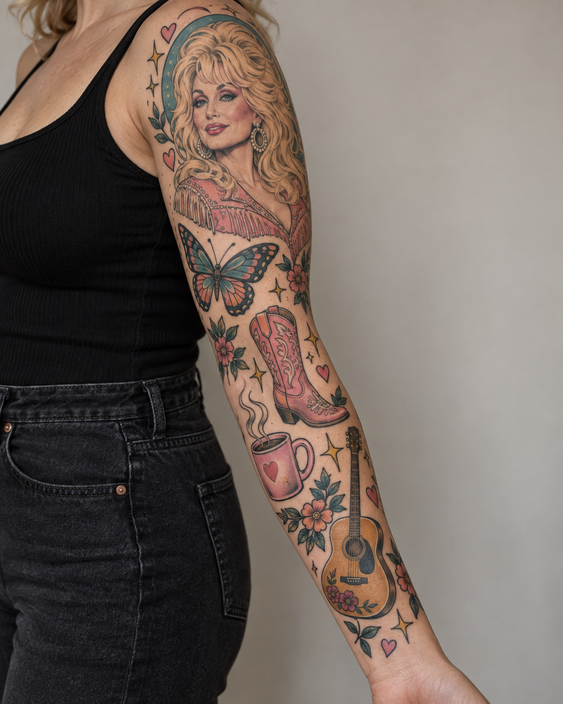 A person's arm features a Dolly Parton portrait tattoo above a butterfly, pink cowboy boot, steaming mug with a heart, and acoustic guitar, surrounded by flowers and stars.