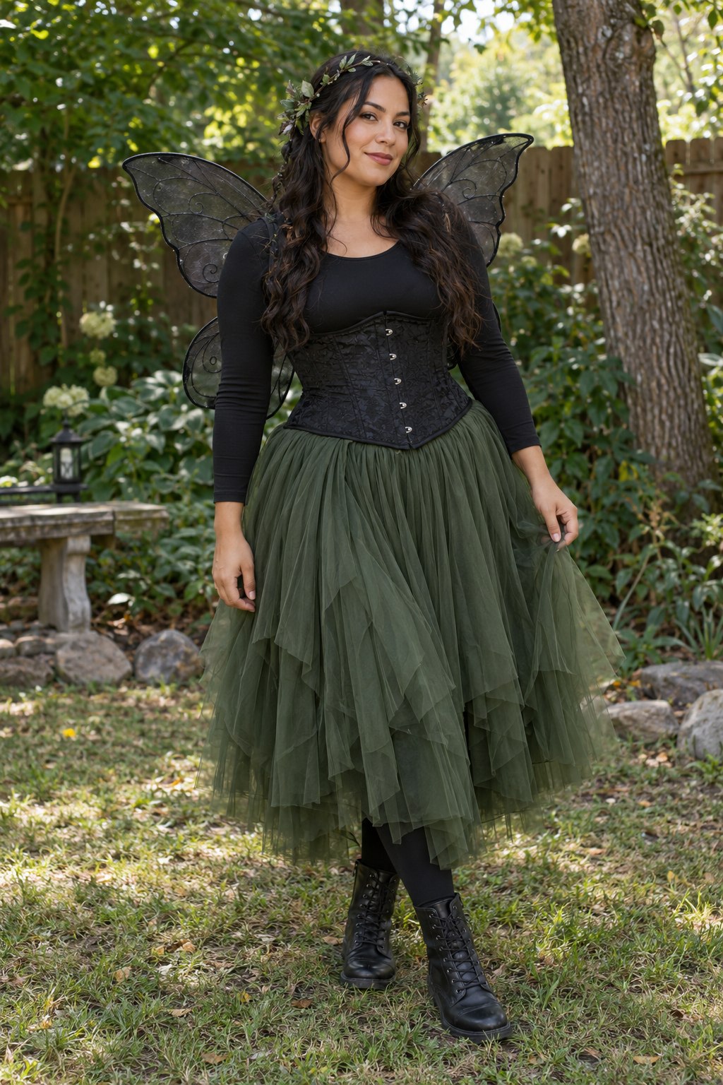 Dark fairy costume with a black corset, moss green tulle skirt, black mesh wings and leafy headband