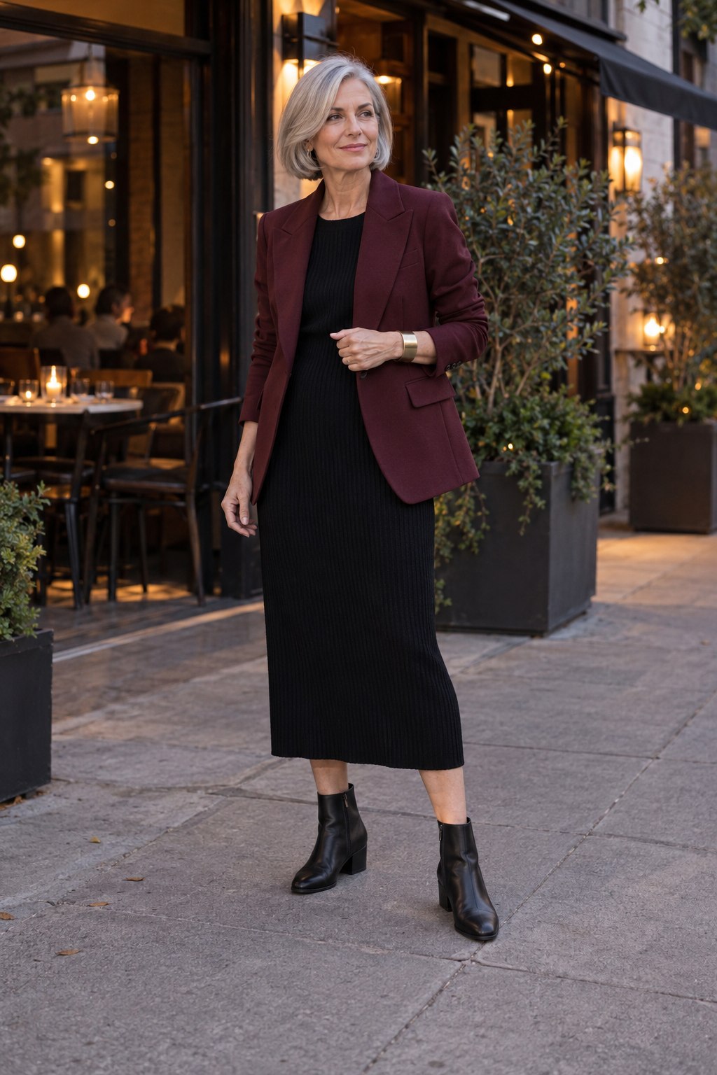 Burgundy blazer over a comfortable black knit midi dress with low-heel boots.