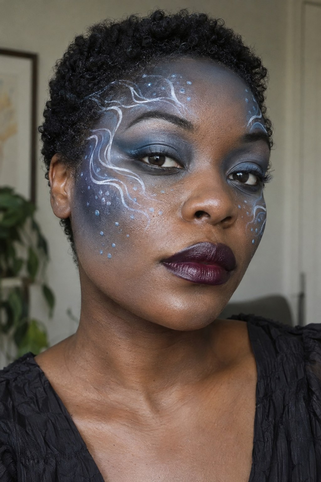 Halloween makeup with blue-gray shading and curved pearl-white lines like underwater ripples on the temples.