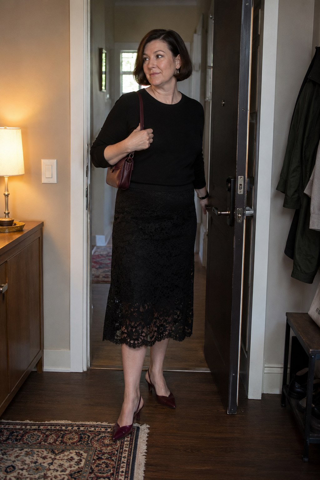 Black lace skirt and fine black knit with burgundy slingbacks and a matching small bag.