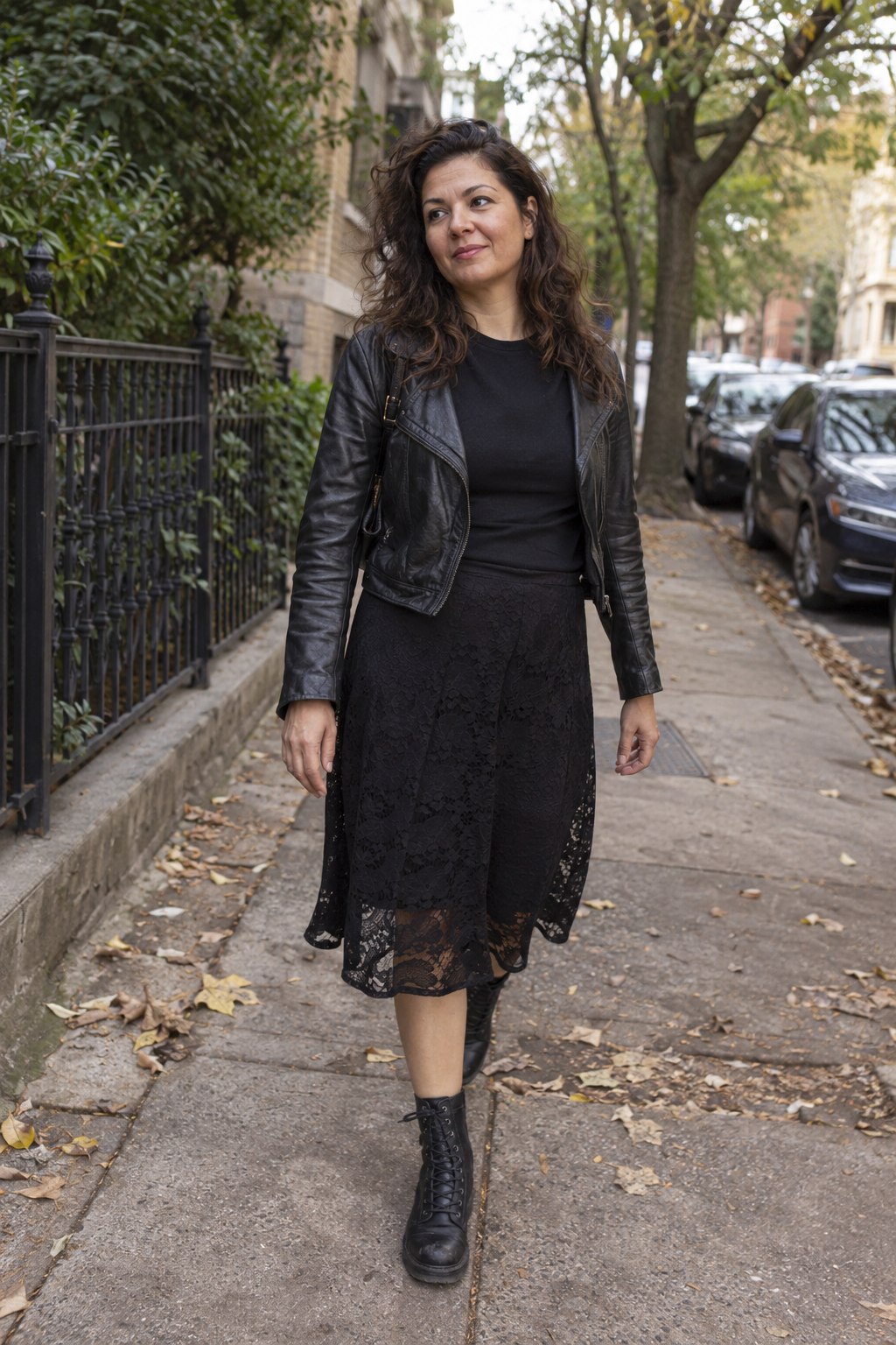 Black lace skirt with a cropped leather jacket and flat lace-up boots.