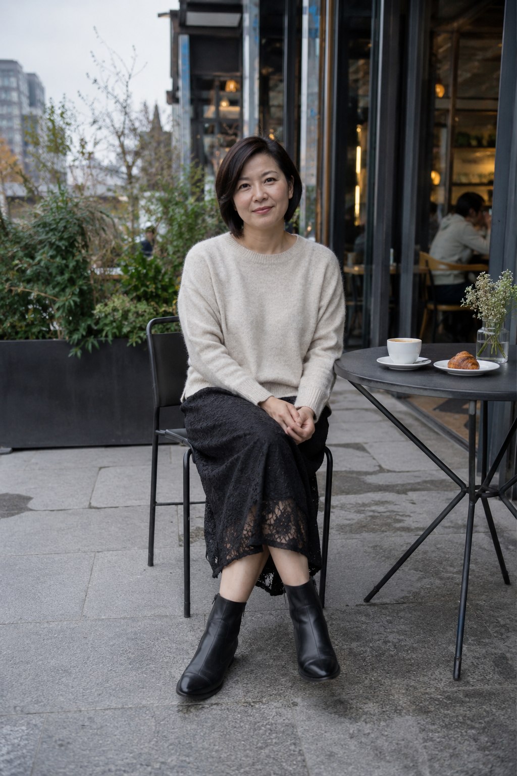 Black lace midi skirt with a loose oatmeal sweater and flat ankle boots.
