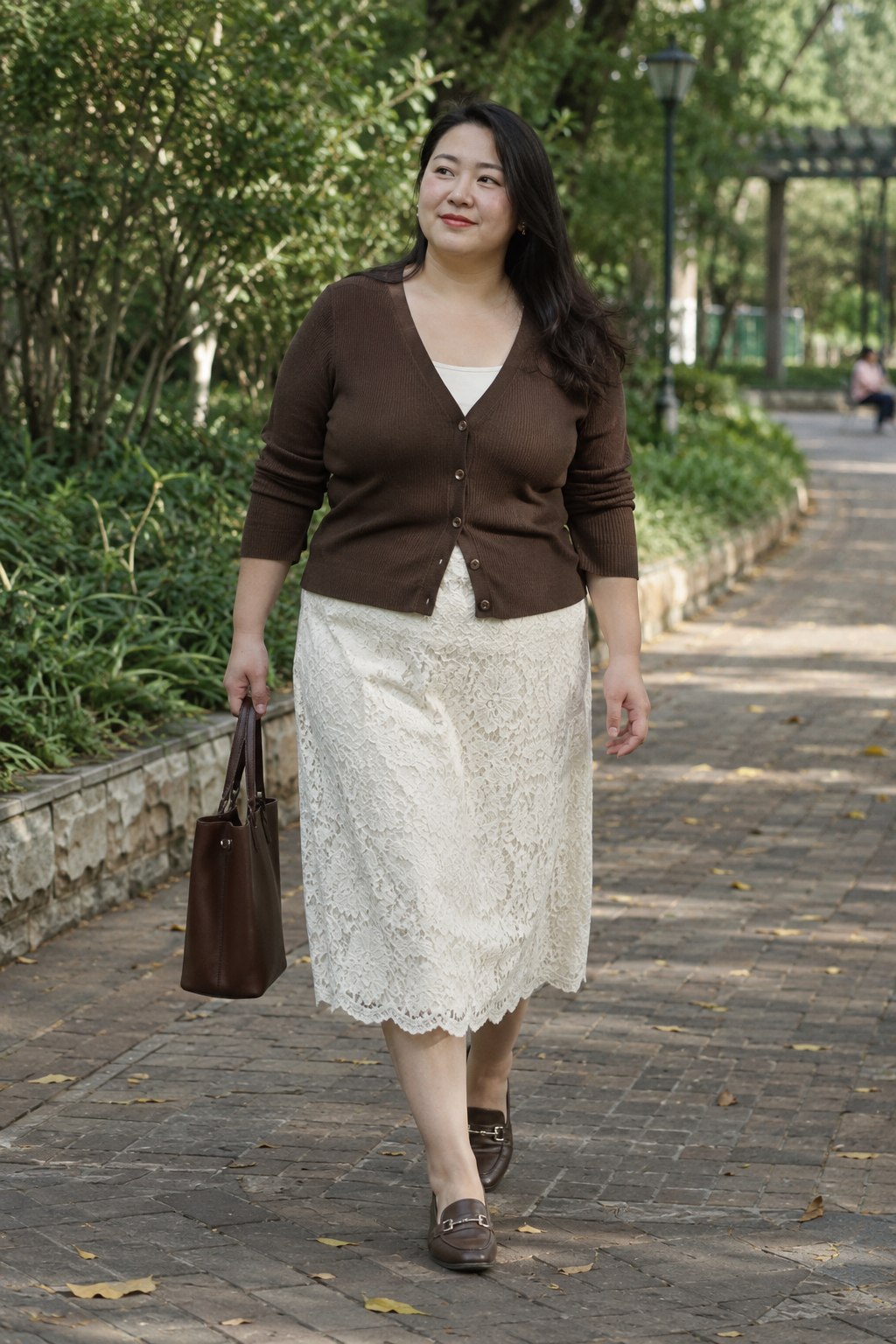 Cream lace skirt with a chocolate cardigan and brown loafers.