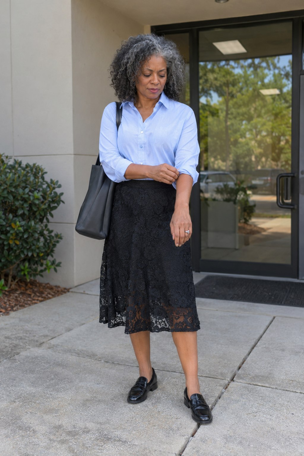 Black lace midi skirt with a pale blue button-down and black loafers.