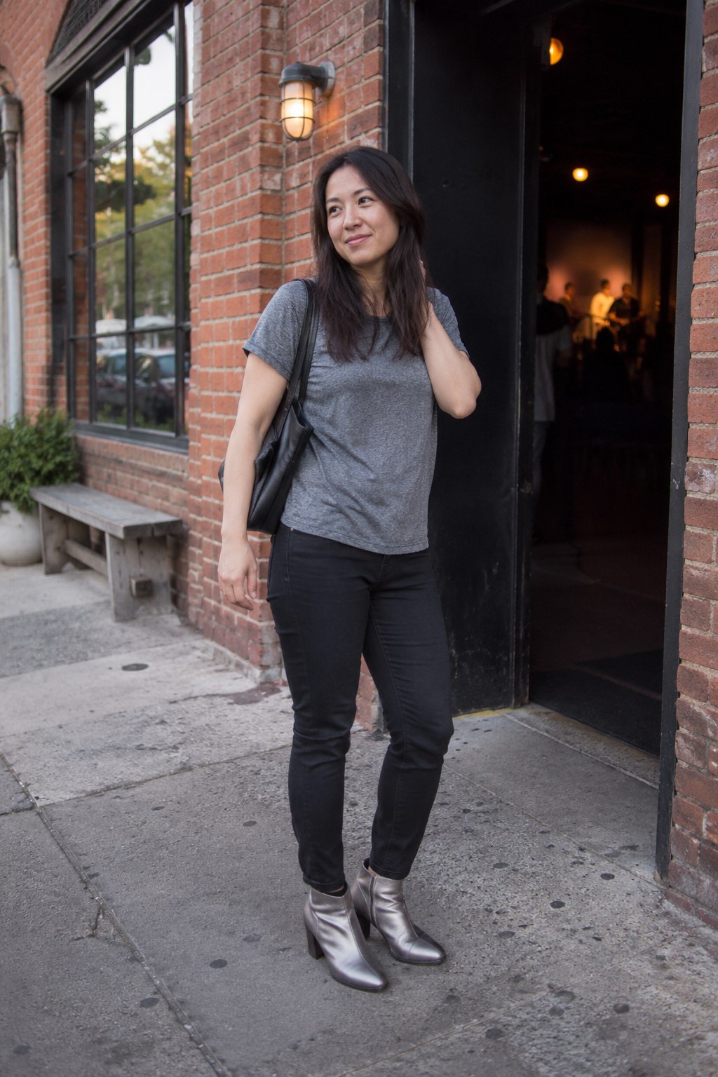 Silver ankle boots with black straight-leg jeans and a gray tee.